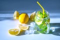 Water with sliced Ã¢â¬â¹Ã¢â¬â¹lemon and mint leaves in a transparent glass mug with a yellow straw and sliced Ã¢â¬â¹Ã¢â¬â¹slices of lemon Royalty Free Stock Photo